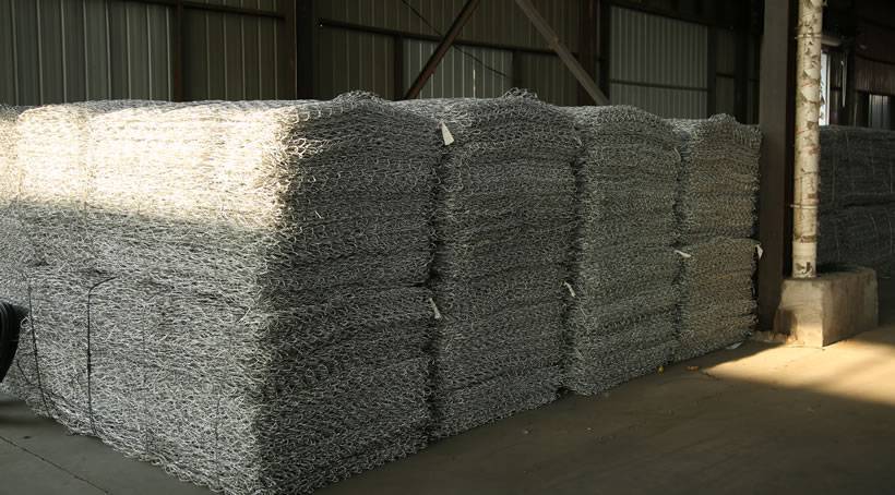 Several bundled of galvanized woven gabions in the warehouse.
